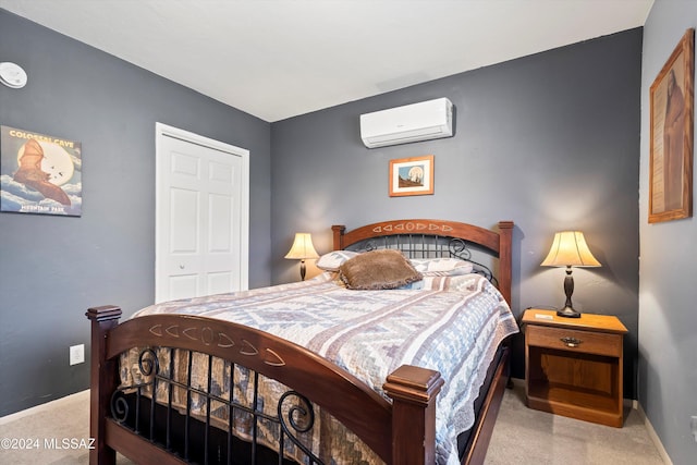 carpeted bedroom with a wall mounted AC and a closet