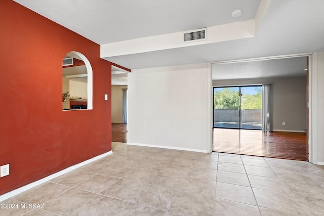 unfurnished room featuring light tile patterned flooring