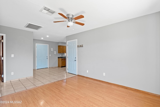 unfurnished room featuring ceiling fan and light hardwood / wood-style flooring