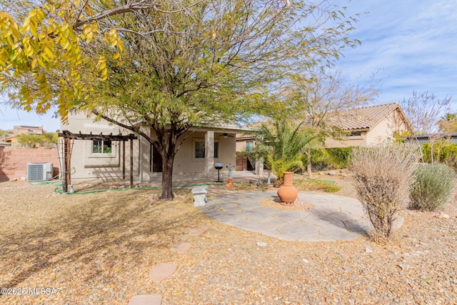 rear view of property with a pergola, a patio area, and central air condition unit