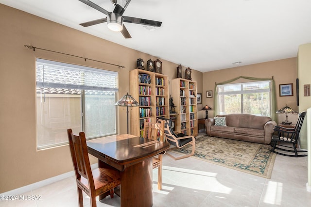 tiled dining space with a wealth of natural light and ceiling fan