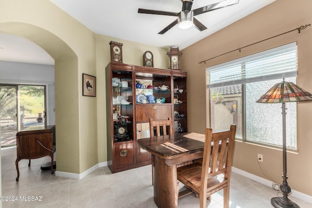 tiled dining space with a wealth of natural light and ceiling fan