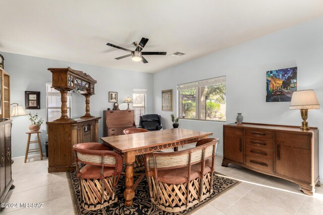 kitchen with light tile patterned flooring, a center island, and decorative light fixtures