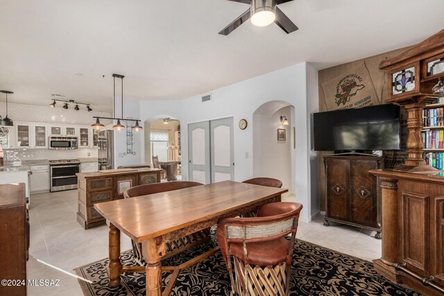 dining space featuring light tile patterned floors and ceiling fan