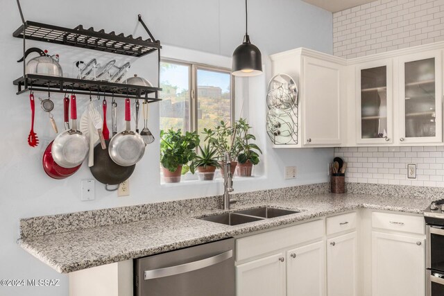 kitchen featuring white cabinetry, stainless steel appliances, sink, and light stone counters