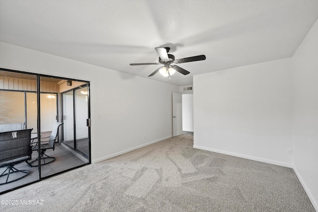 carpeted empty room featuring ceiling fan