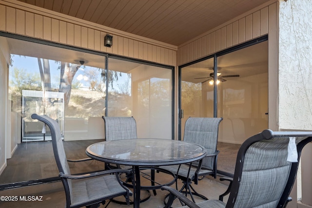 sunroom / solarium featuring ceiling fan and wood ceiling