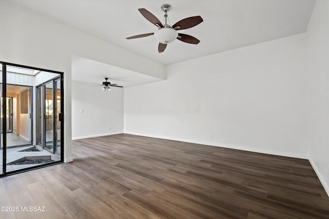 unfurnished room featuring ceiling fan and dark wood-type flooring