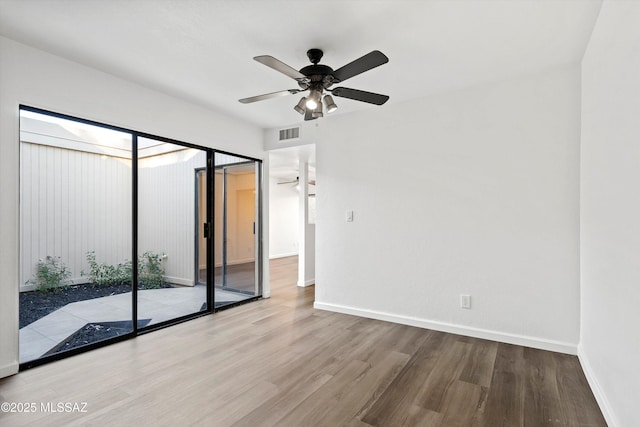 unfurnished room featuring ceiling fan and hardwood / wood-style floors