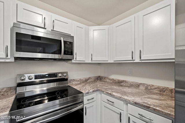 kitchen featuring stainless steel appliances and white cabinetry