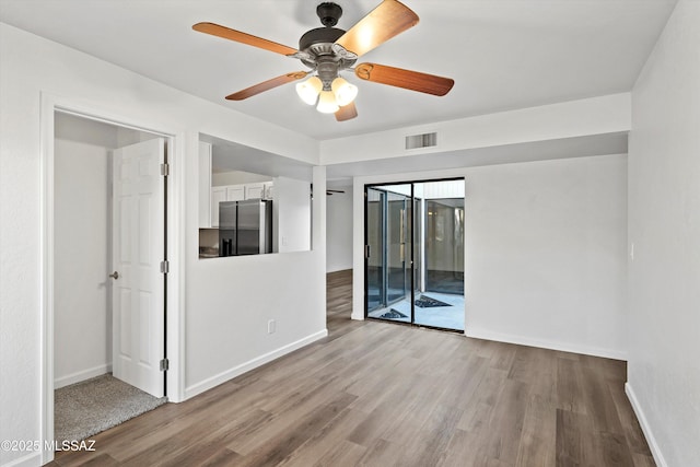 spare room featuring ceiling fan and light hardwood / wood-style flooring