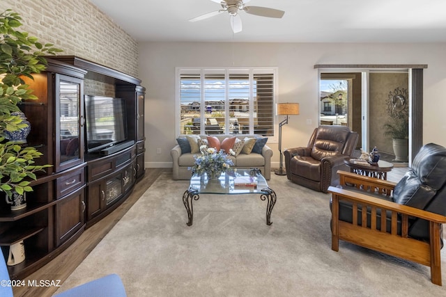 living room with brick wall and ceiling fan