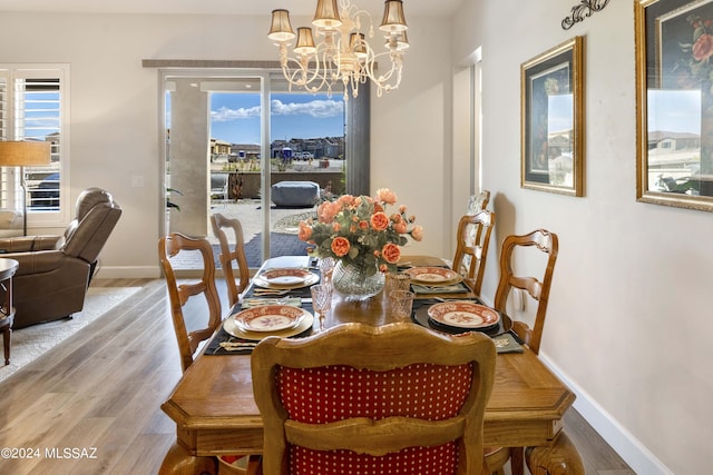 dining area featuring hardwood / wood-style flooring and a chandelier