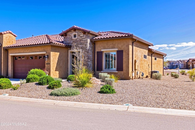 mediterranean / spanish-style house with a garage