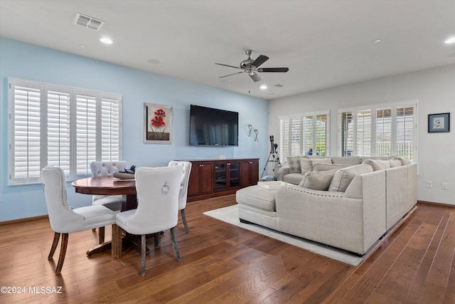 living room with dark wood-type flooring, recessed lighting, and visible vents