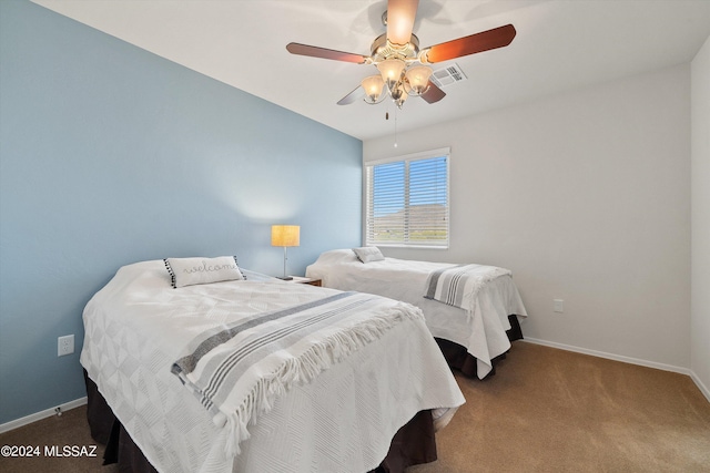 bedroom featuring carpet floors, visible vents, baseboards, and a ceiling fan