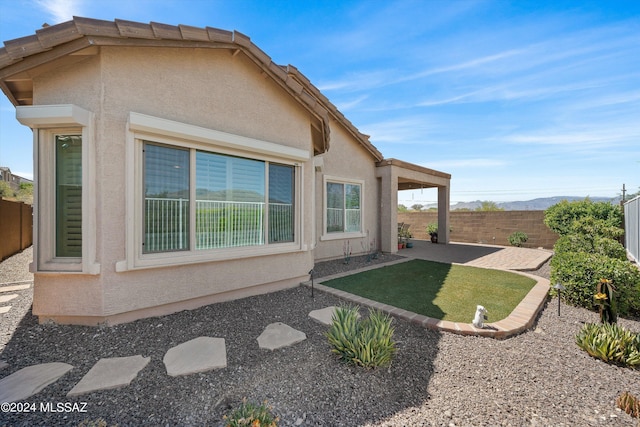 exterior space featuring a patio area and a fenced backyard