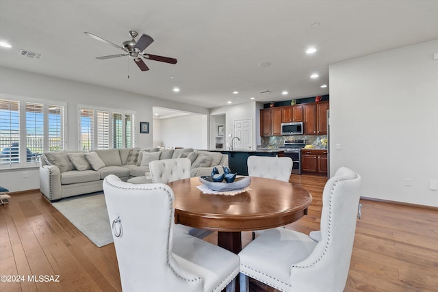 dining space with light wood-style flooring, visible vents, ceiling fan, and recessed lighting