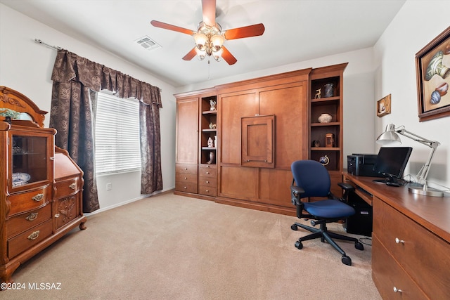 office with a ceiling fan, visible vents, light carpet, and baseboards