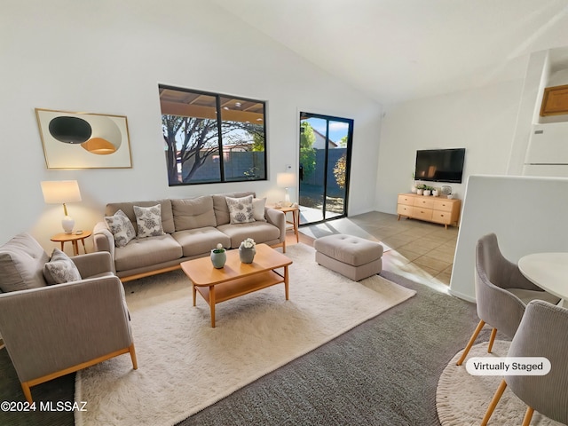 unfurnished room featuring light colored carpet and lofted ceiling