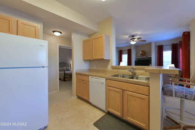 kitchen with light tile patterned flooring, sink, white appliances, light brown cabinets, and ceiling fan