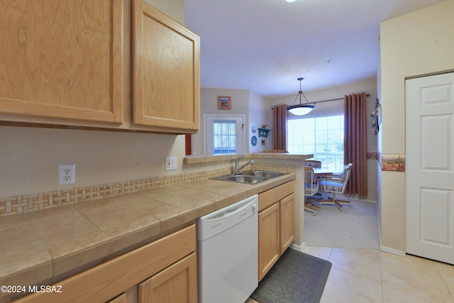 kitchen with sink, tile countertops, dishwasher, and light brown cabinets