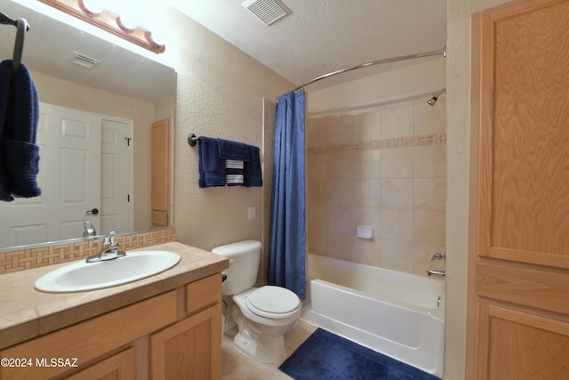 full bathroom featuring vanity, a textured ceiling, toilet, and shower / bath combo with shower curtain