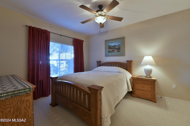 bedroom with ceiling fan and light carpet