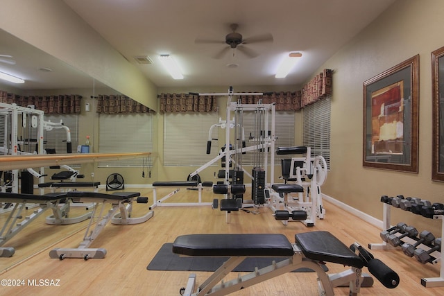 workout area featuring wood-type flooring and ceiling fan