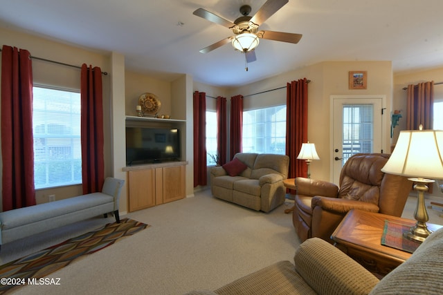 carpeted living room with ceiling fan