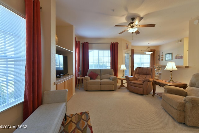 carpeted living room featuring ceiling fan