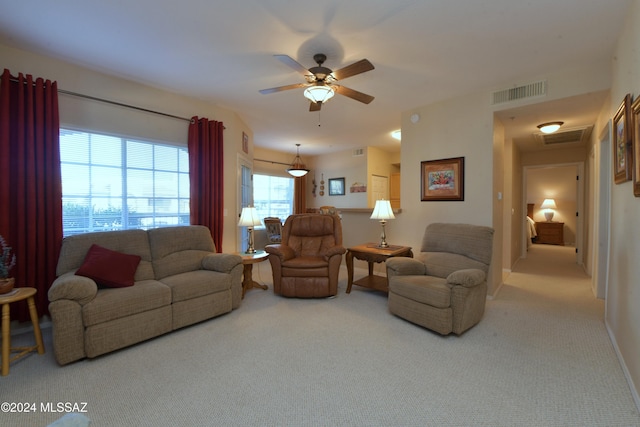 carpeted living room featuring ceiling fan