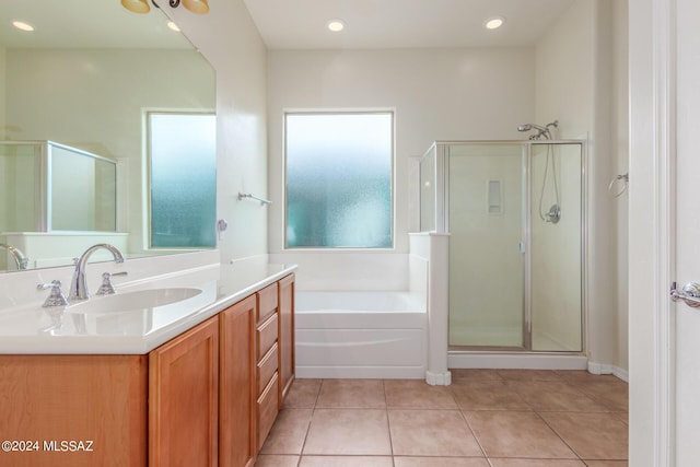 bathroom with vanity, tile patterned floors, and plus walk in shower