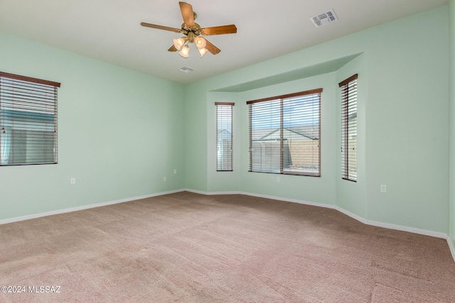 unfurnished room featuring ceiling fan and light colored carpet