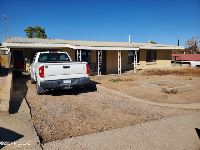 single story home featuring a carport