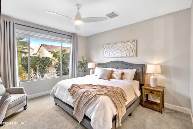 bedroom featuring light carpet and ceiling fan