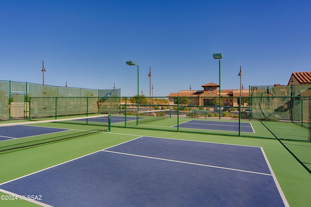 view of tennis court featuring basketball hoop