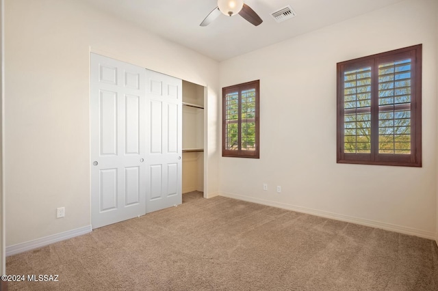 unfurnished bedroom featuring ceiling fan, a closet, and carpet floors