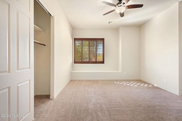 unfurnished bedroom with ceiling fan, a closet, and light colored carpet