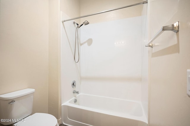 bathroom featuring bathing tub / shower combination and toilet