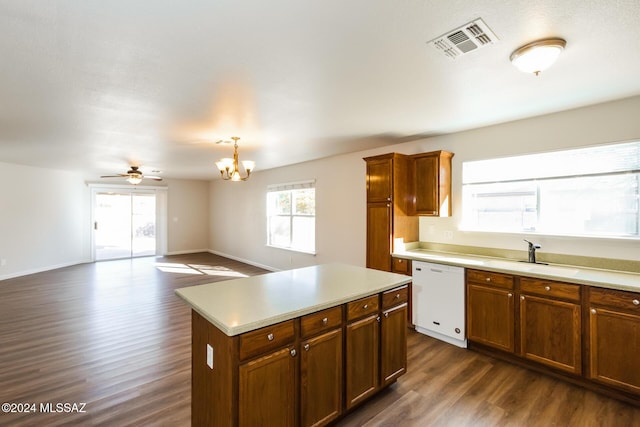 kitchen featuring a center island, sink, hanging light fixtures, white dishwasher, and ceiling fan with notable chandelier