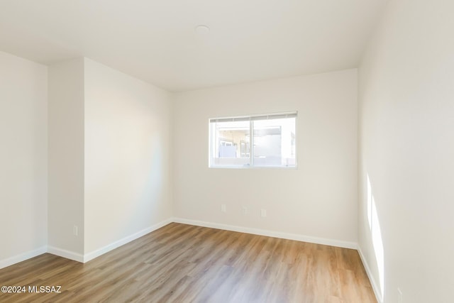 unfurnished room with light hardwood / wood-style flooring