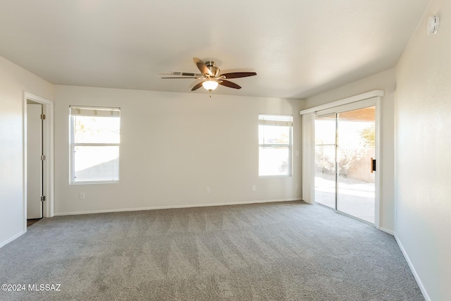 carpeted empty room featuring ceiling fan