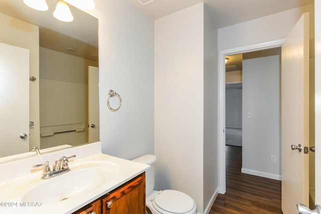 bathroom with hardwood / wood-style floors, vanity, and toilet