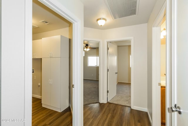 hallway with dark hardwood / wood-style flooring