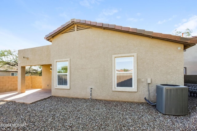 back of property with a patio and cooling unit