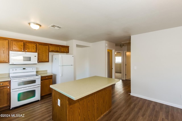 kitchen featuring a center island, dark hardwood / wood-style floors, and white appliances