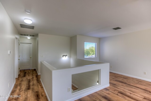 spare room with hardwood / wood-style flooring and ceiling fan