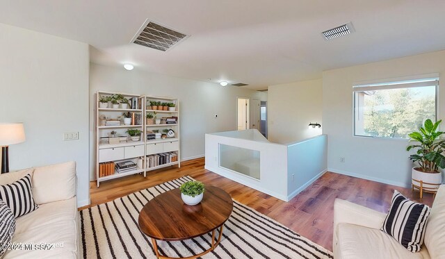 unfurnished living room featuring ceiling fan and wood-type flooring