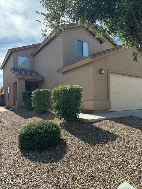 view of side of property featuring a garage